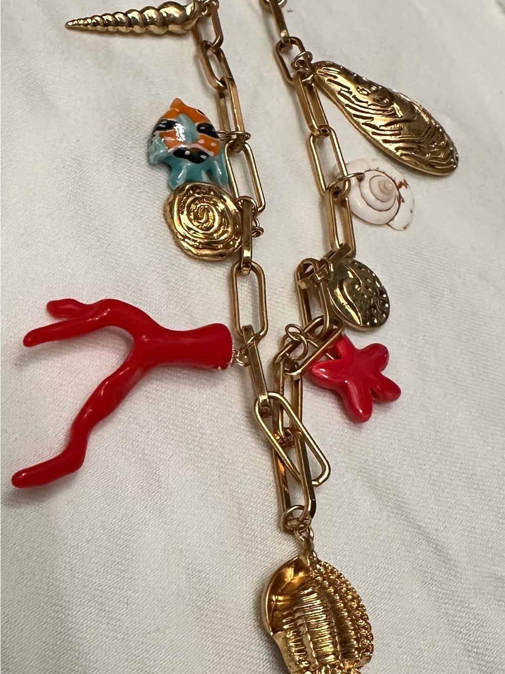 Gold Charm Necklace with Red Coral and Shell Accents